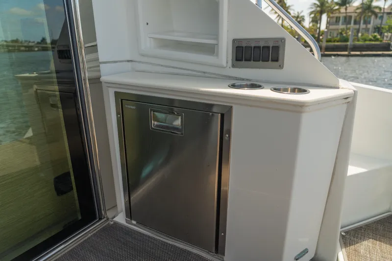 Duke Yacht Photos Pics 2018 Cruisers Yachts 50 Cantius interior with stainless steel fridge and cup holders.