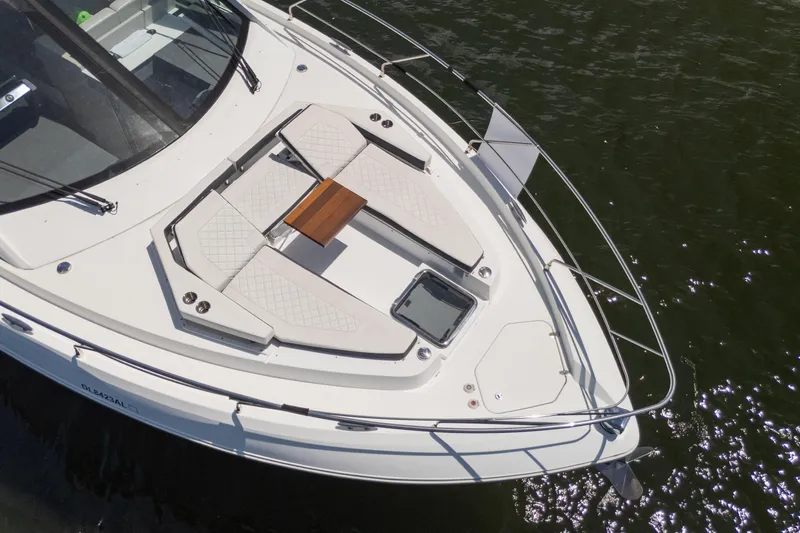 Duke Yacht Photos Pics 2018 Cruisers Yachts 50 Cantius boat deck with seating and table on water.