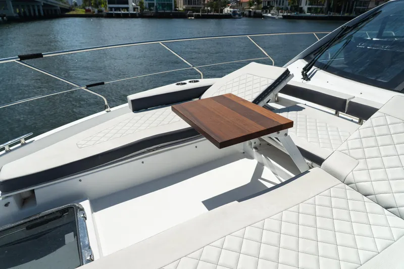 Duke Yacht Photos Pics Luxurious seating area on 2018 Cruisers Yachts 50 Cantius with elegant wood table.