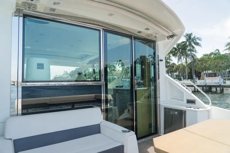 Duke Yacht Photos Pics 2018 Cruisers Yachts 50 Cantius with sleek glass doors and luxurious seating on deck.