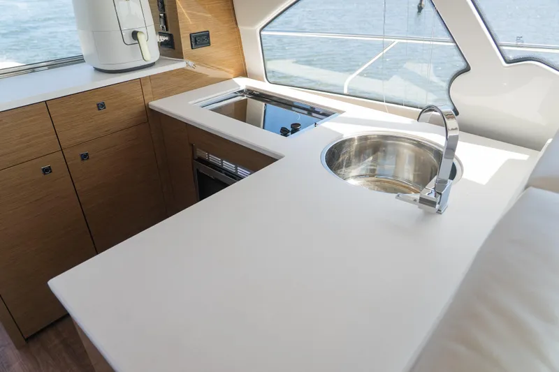 Duke Yacht Photos Pics Luxurious kitchen area on 2018 Cruisers Yachts 50 Cantius with modern sink and appliances.