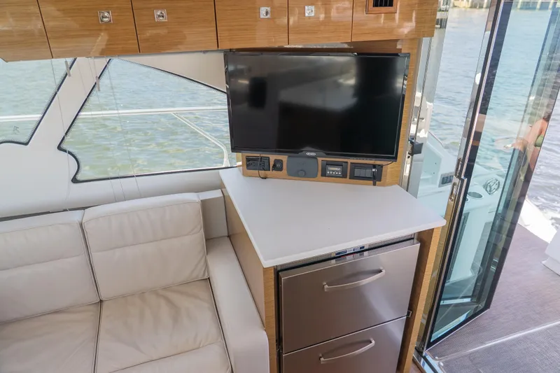 Duke Yacht Photos Pics Interior of 2018 Cruisers Yachts 50 Cantius with TV, sofa, and drawers.