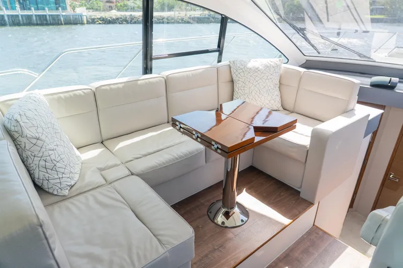 Duke Yacht Photos Pics Luxurious 2018 Cruisers Yachts 50 Cantius interior with plush seating and elegant table.