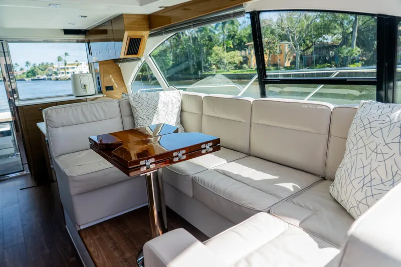Duke Yacht Photos Pics Luxurious interior of 2018 Cruisers Yachts 50 Cantius with plush seating and elegant table.