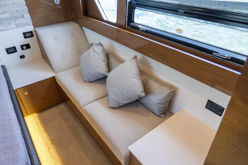 Duke Yacht Photos Pics Luxurious interior seating on 2018 Cruisers Yachts 50 Cantius with cushions and window view.