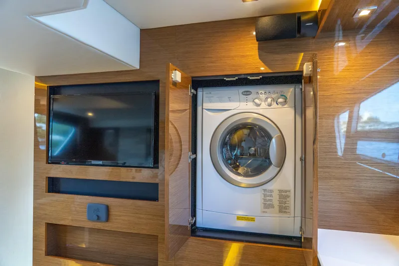 Duke Yacht Photos Pics Laundry area with washer and TV on 2018 Cruisers Yachts 50 Cantius.