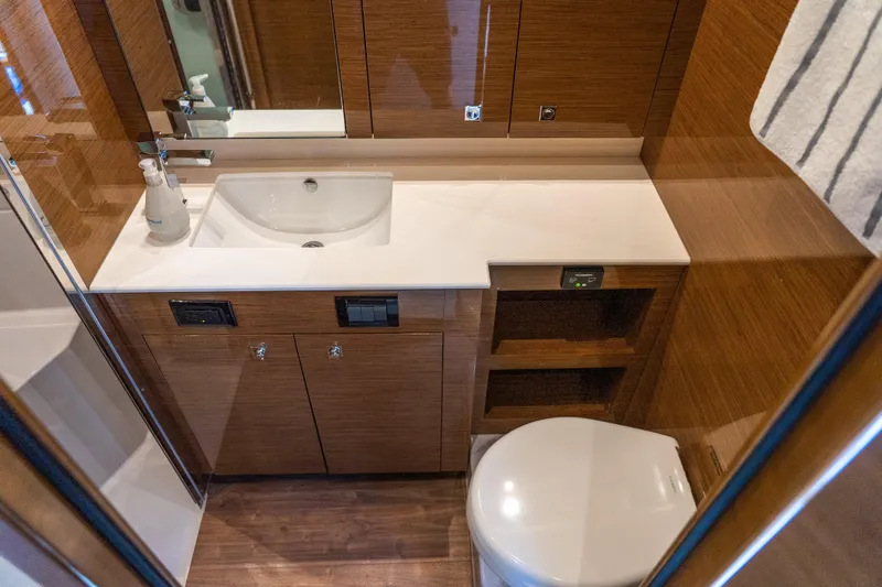 Duke Yacht Photos Pics Luxurious bathroom in 2018 Cruisers Yachts 50 Cantius with modern fixtures and wood finish.