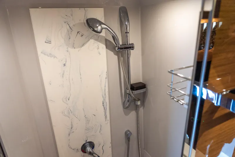 Duke Yacht Photos Pics Shower area in 2018 Cruisers Yachts 50 Cantius with modern fixtures and marble accents.