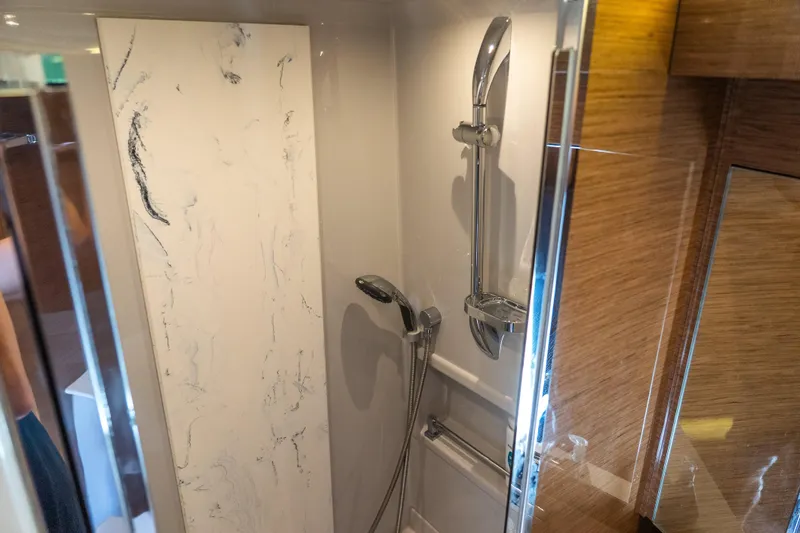 Duke Yacht Photos Pics Luxurious shower in 2018 Cruisers Yachts 50 Cantius with marble accents and modern fixtures.