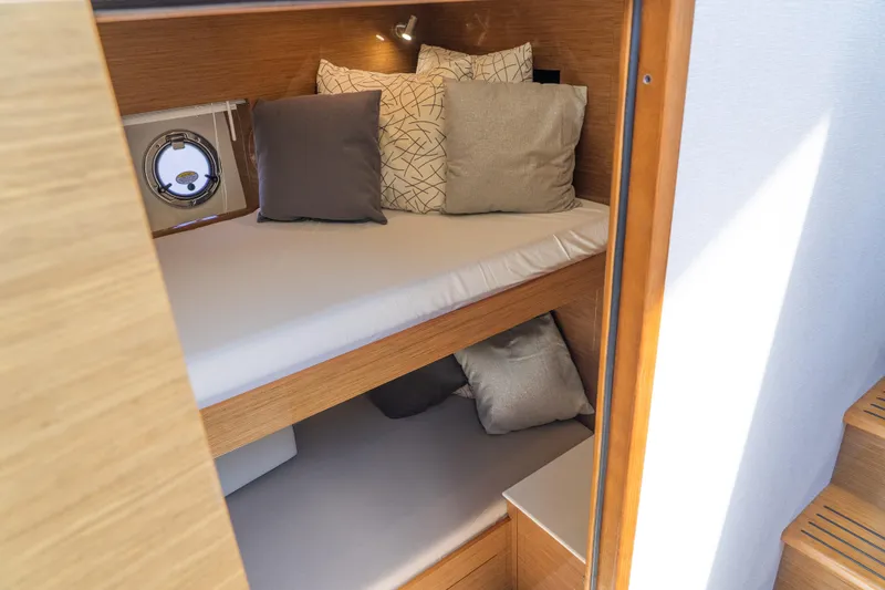 Duke Yacht Photos Pics 2018 Cruisers Yachts 50 Cantius cabin with cozy bunk beds and stylish cushions.
