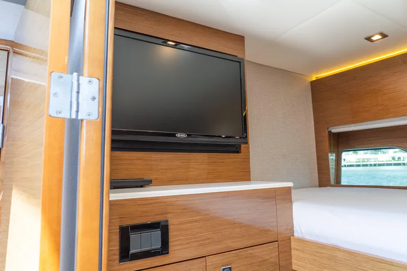 Duke Yacht Photos Pics Interior of 2018 Cruisers Yachts 50 Cantius with TV and wooden cabinetry.