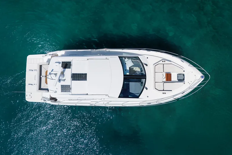 Duke Yacht Photos Pics Overhead view of 2018 Cruisers Yachts 50 Cantius on clear blue water.