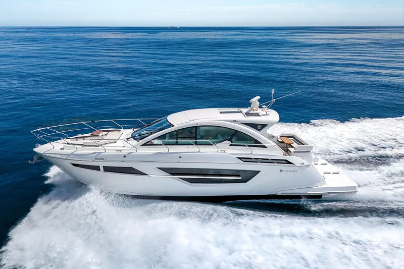 Duke Yacht Photos Pics 2018 Cruisers Yachts 50 Cantius cruising on open water, showcasing sleek design and luxury.
