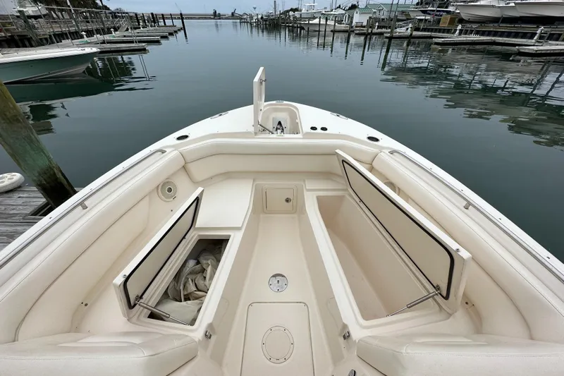  Yacht Photos Pics 2018 Grady-White Freedom 285 boat interior with open storage compartments at a marina.