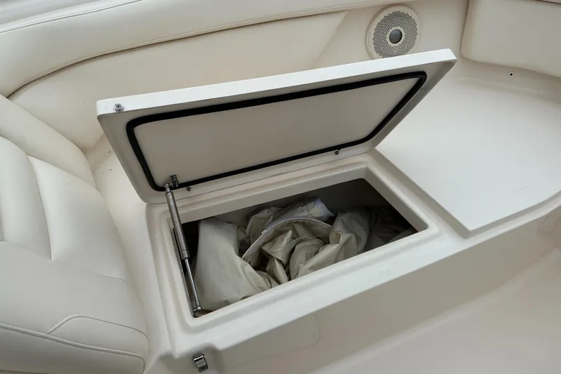  Yacht Photos Pics Open storage compartment on 2018 Grady-White Freedom 285 boat, featuring white interior and speaker.