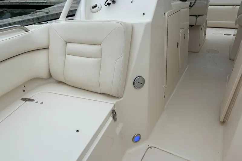  Yacht Photos Pics 2018 Grady-White Freedom 285 boat interior with beige seating and control panel.