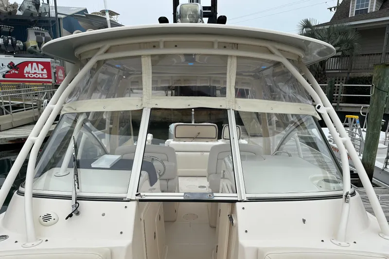  Yacht Photos Pics 2018 Grady-White Freedom 285 boat with enclosed cockpit, docked at marina.
