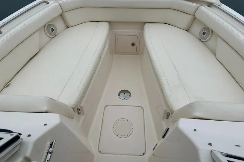  Yacht Photos Pics 2018 Grady-White Freedom 285 boat interior with white cushioned seating and storage compartments.