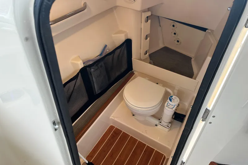  Yacht Photos Pics 2018 Grady-White Freedom 285 boat interior with compact marine toilet and storage.
