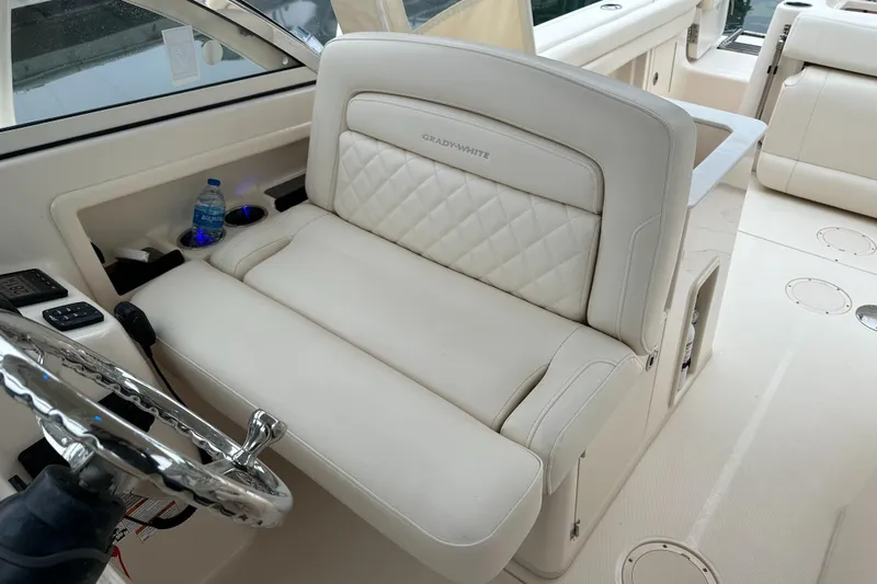  Yacht Photos Pics 2018 Grady-White Freedom 285 boat interior with luxurious seating and steering wheel.