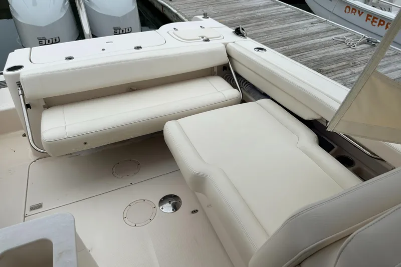  Yacht Photos Pics 2018 Grady-White Freedom 285 boat interior with beige seating and docked engines.