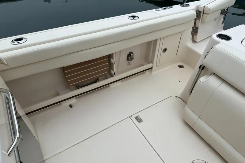  Yacht Photos Pics 2018 Grady-White Freedom 285 boat interior with white seating and storage compartments.