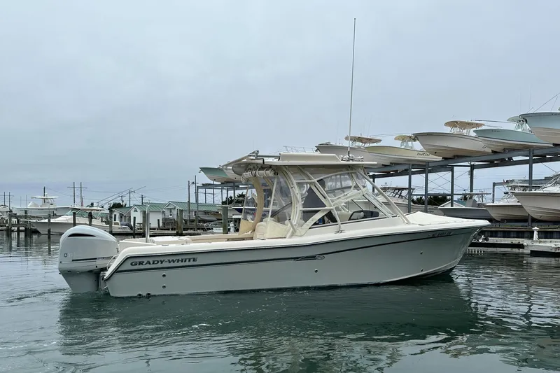  Yacht Photos Pics 2018 Grady-White Freedom 285 boat docked in marina, calm water, overcast sky.