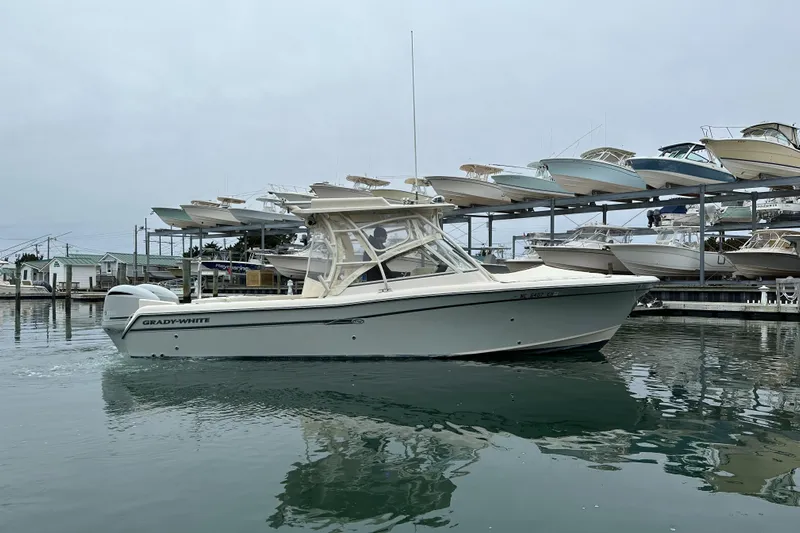  Yacht Photos Pics 2018 Grady-White Freedom 285 boat docked in marina, surrounded by stacked boats.