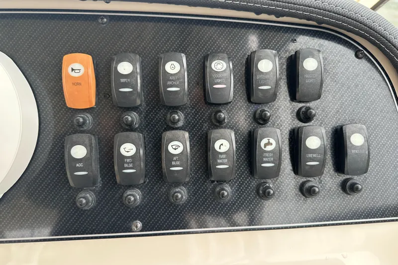 Yacht Photos Pics Control panel of a 2018 Grady-White Freedom 285 boat with labeled switches.