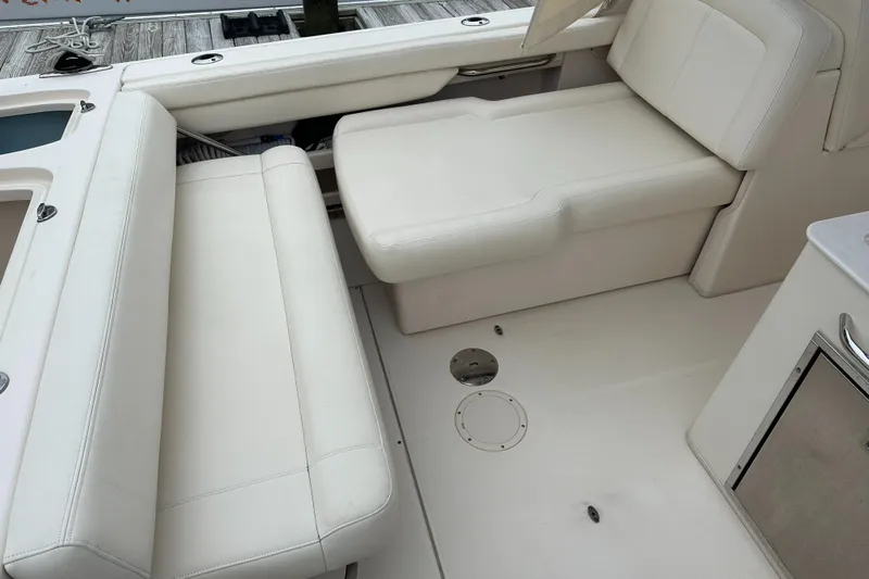 Yacht Photos Pics 2018 Grady-White Freedom 285 boat interior with white cushioned seating.
