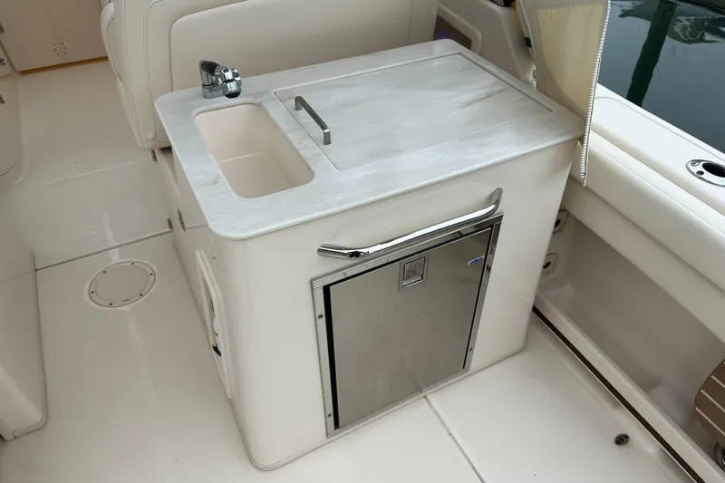  Yacht Photos Pics 2018 Grady-White Freedom 285 boat interior with sink and storage cabinet.