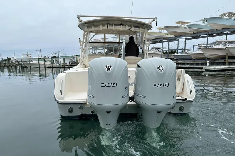  Yacht Photos Pics 2018 Grady-White Freedom 285 boat with twin 300 horsepower engines on calm water.