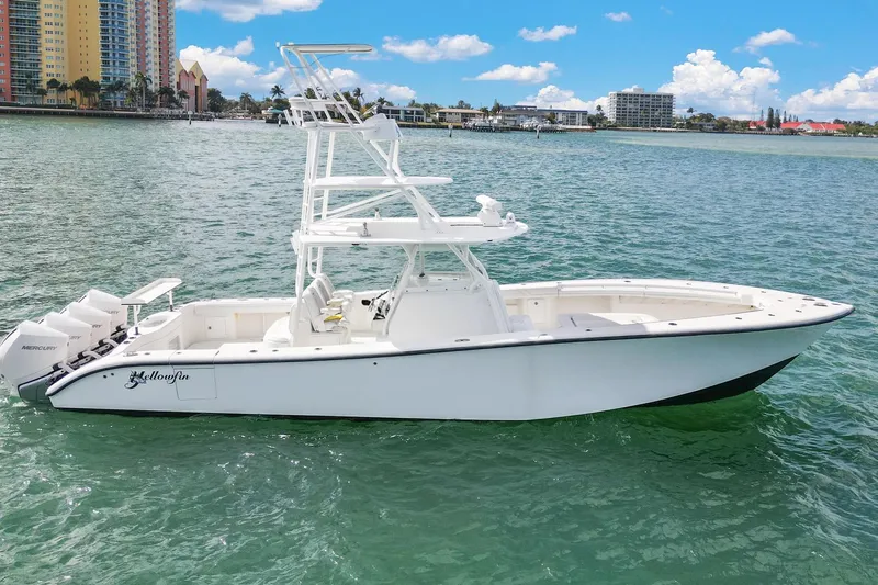  Yacht Photos Pics 2015 Yellowfin 39 Offshore boat on clear water with cityscape background.