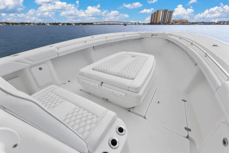  Yacht Photos Pics 2015 Yellowfin 39 Offshore boat interior with cushioned seating, ocean view, and city skyline.