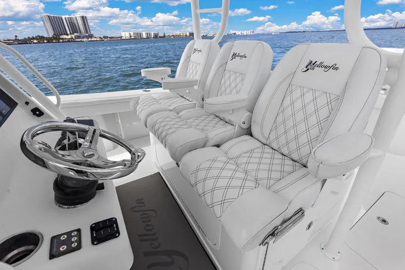  Yacht Photos Pics 2015 Yellowfin 39 Offshore boat interior with luxurious seating and steering wheel, ocean view.