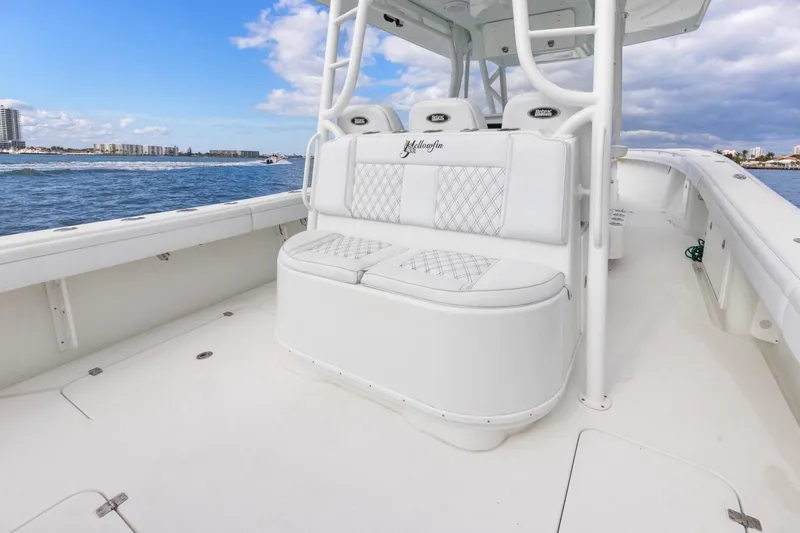  Yacht Photos Pics 2015 Yellowfin 39 Offshore boat with white seating, cruising on a sunny day.
