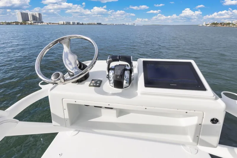  Yacht Photos Pics 2015 Yellowfin 39 Offshore boat helm with steering wheel and navigation display.