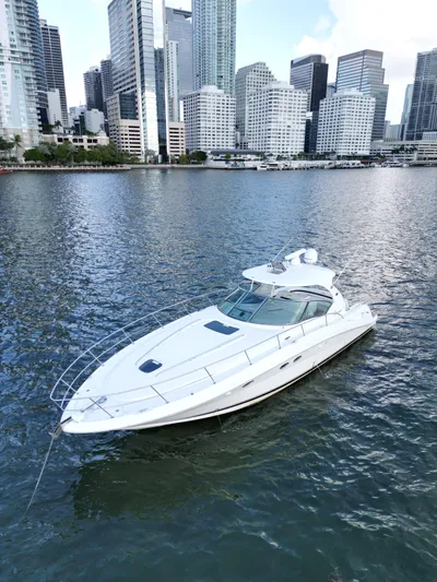  Yacht Photos Pics 2005 Sea Ray 44 Sundancer yacht on urban waterfront with skyscrapers in background.