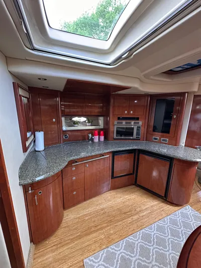  Yacht Photos Pics Luxurious 2005 Sea Ray 44 Sundancer yacht kitchen with wood cabinetry and granite countertops.
