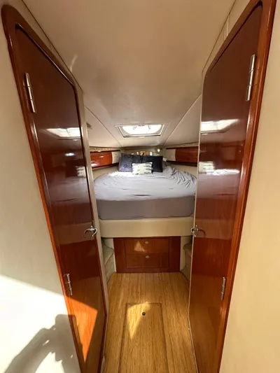  Yacht Photos Pics 2005 Sea Ray 44 Sundancer cabin interior with bed and wooden finishes.