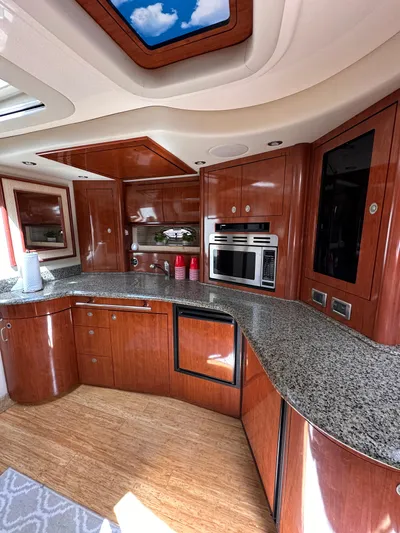  Yacht Photos Pics Luxurious 2005 Sea Ray 44 Sundancer yacht kitchen with wood cabinetry and granite countertops.