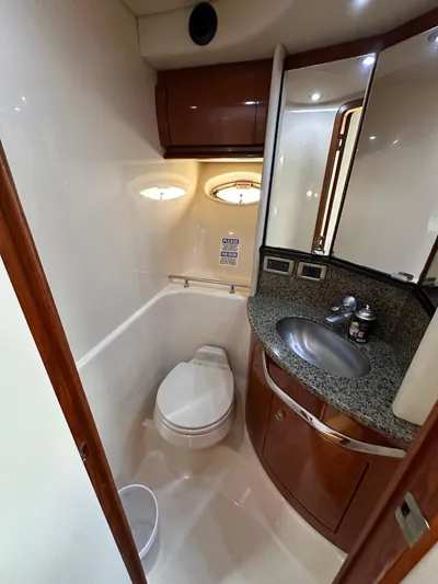  Yacht Photos Pics 2005 Sea Ray 44 Sundancer yacht bathroom with modern fixtures and elegant wood cabinetry.
