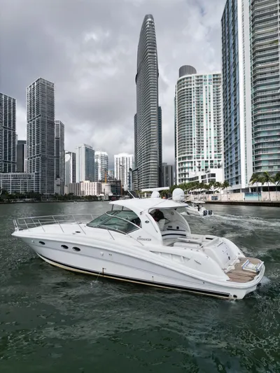  Yacht Photos Pics 2005 Sea Ray 44 Sundancer yacht cruising near city skyscrapers.