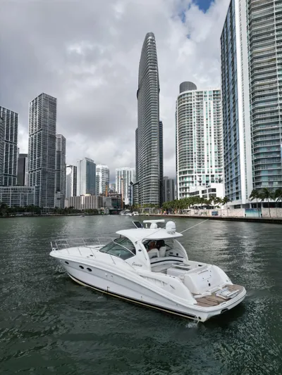  Yacht Photos Pics Sea Ray 44 Sundancer yacht cruising in urban waterfront, 2005 model.