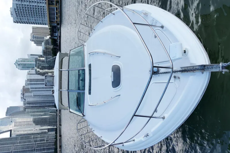  Yacht Photos Pics 2005 Sea Ray 44 Sundancer yacht docked in urban waterfront setting.