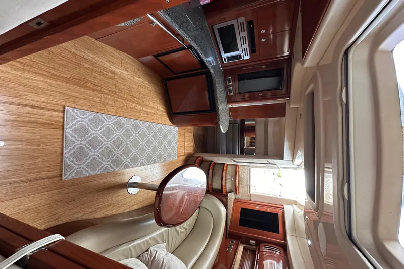  Yacht Photos Pics Luxurious interior of 2005 Sea Ray 44 Sundancer yacht with modern kitchen and seating area.