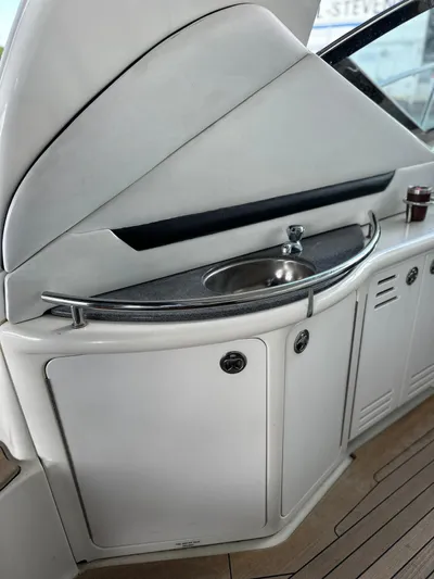  Yacht Photos Pics 2005 Sea Ray 44 Sundancer yacht interior with sink and storage cabinets.