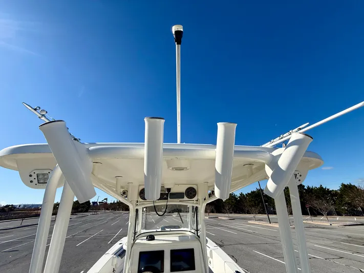 Reelaxing Yacht Photos Pics 2017 World Cat 295 CC boat with rod holders, clear blue sky background.