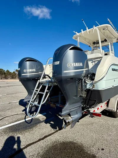 Reelaxing Yacht Photos Pics 2017 World Cat 295 CC with dual Yamaha engines on a trailer under clear blue sky.