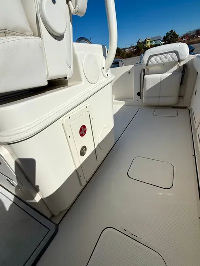 Reelaxing Yacht Photos Pics 2017 World Cat 295 CC boat interior with white seating and storage compartments.